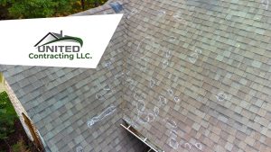 Aerial view of a roof with visible hail damage circled in chalk, inspected by United Contracting LLC.