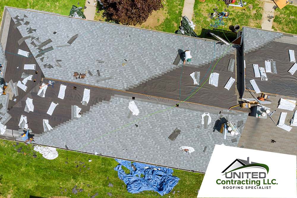 roofers working on roof repair replace shingle that has been damage