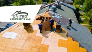 Aerial view of a team of workers installing the roof of a house, laying new tiles or roofing material to completely replace the roof.