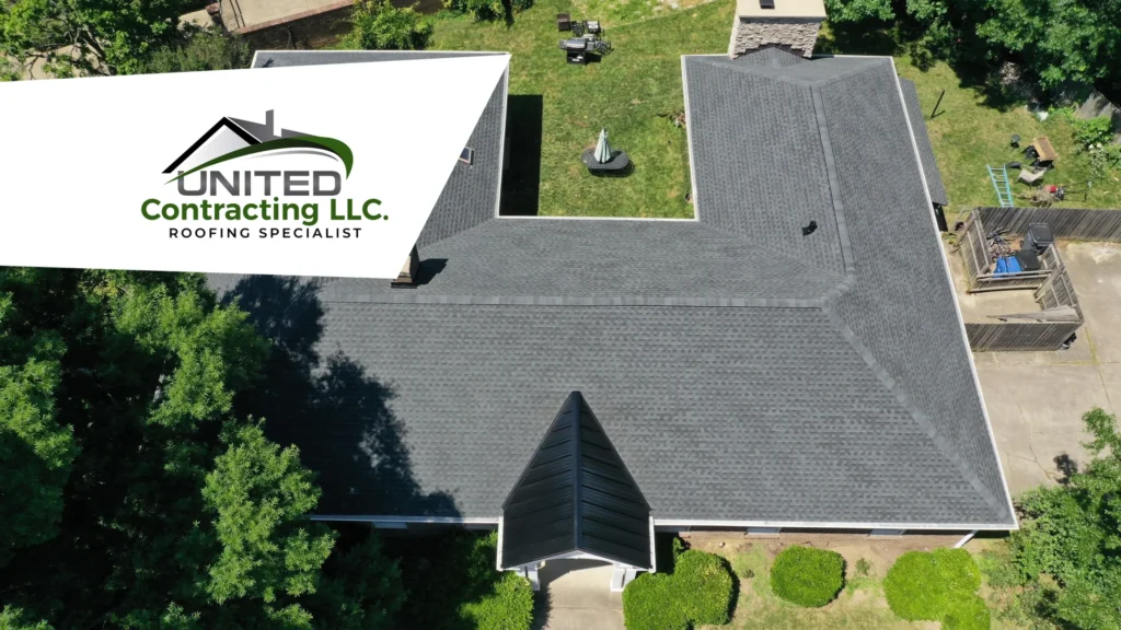 A professional contractor is on a roof performing repairs in Louisville. He appears focused and hard at work maintaining or repairing the roof of a house.